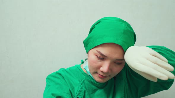 Medical surgeon team nurse feeling tired and sad from working to cure patients during covid 19. alt