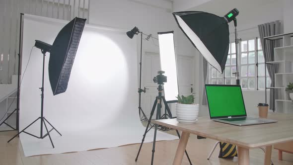 Photo Studio With Professional Equipment And Green Screen Laptop Computer Display alt
