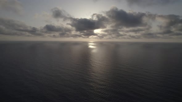 Sunrise over the sea. Epic view of the ocean and reflection of clouds and sun.