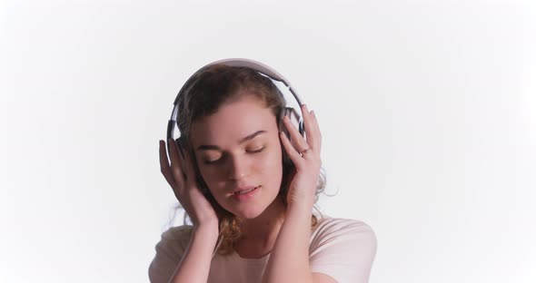 Happy Woman with Headphones Listening Music and Dance on the Isolated Background