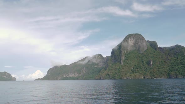 Huge limestone cliffs and calm waters in El Nido, Palawan, the Philippines alt