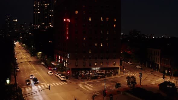 A night-time aerial dolly shot of an old motel building along the streets of Chicago. alt