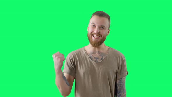 Serious Handsome Man on Chroma Key. Happy Surprised Bearded Tattooed Hipster alt