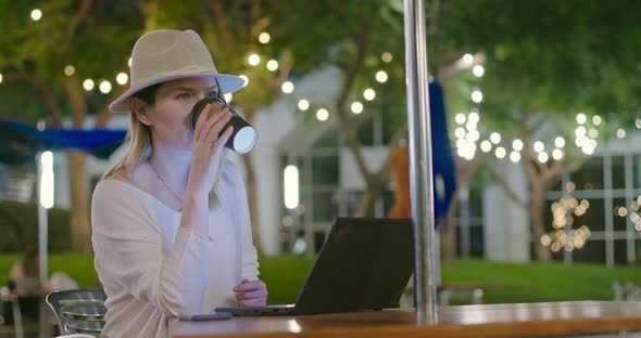 Work From Home or Distant Work Footage. Freelancer Woman Is Drinking Coffee,  alt