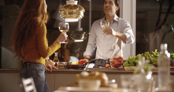Man Prepare Dinner at Home While Woman Drink Wine