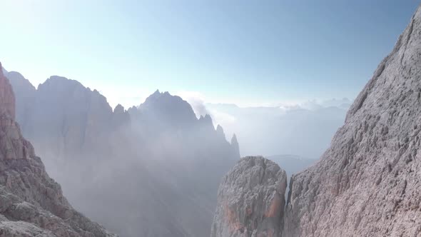 Aerial Fly Over Man Standing at Vajolet Towers in Dolomites Italy alt