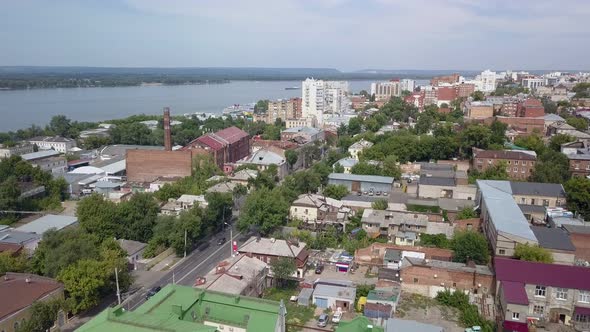 Aerial View on City in Summer Sunny Day, Small and High Houses and River