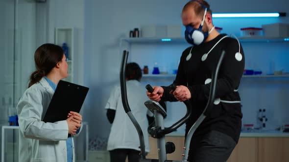 Team of Doctor Researchers Monitoring Endurance of Man alt