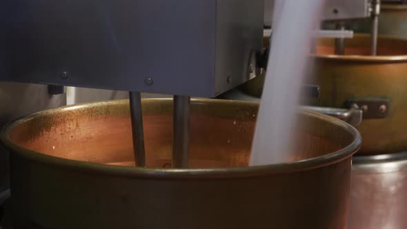 Mixing ingredients for chocolate fudge at candy factory