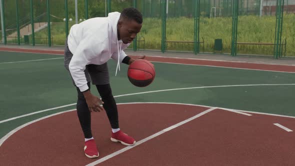Black Man Dribbling Basketball Outside alt
