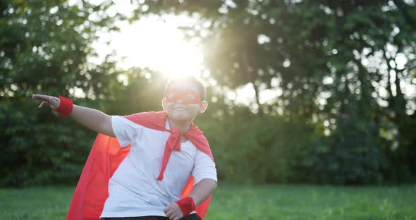 Fat super hero kid dancing in garden alt