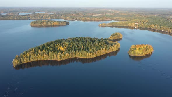 The Aerial View of the Island Trees in the Middle of Lake Saimaa on a Sunny Day alt