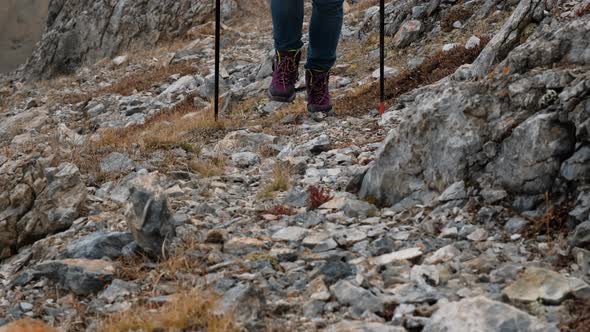 Closeup of Woman Traveler Crossing Rocky Terrain alt