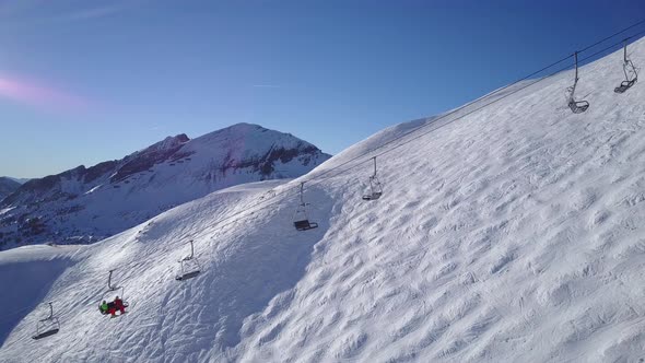 Drone View Two Skiers Going up With Chair Lift alt