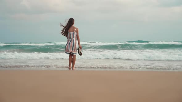 Young Woman Looking to Storm at Seashore alt