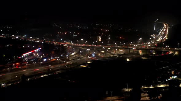 Aerial View of Highway Interchange at Night Timelapse alt