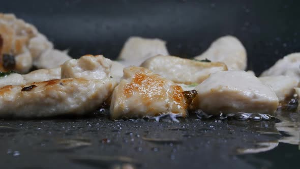 Pieces of White Turkey Meat Fried in Hot Oil are Bubbling and Sizzling