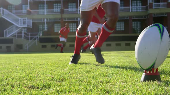 Rugby player kicking the ball from the kicking tee in the stadium 4k