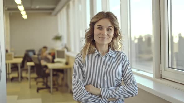 Confident Woman Standing in Office Gives Kind Friendly Look at Camera Smiles Irrl alt