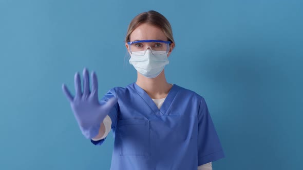 Healthcare worker showing stop gesture, to control an outbreak of virus. Stop the infection!