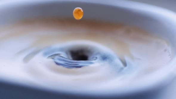 Drop of Coffee Falls Into the Filled Cup alt