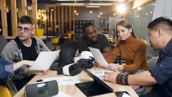 Young Business People Working with Documents while Sitting alt