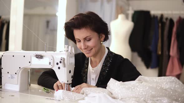Portrait of Female Tailor Working on Sewing Machine alt