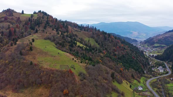 Small Village Along a Road in a Mountain Gorge Carpathian Mountains in Ukraine alt