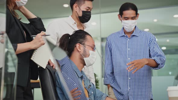 Group of Asian team business people work in office with new normal and meeting brainstorm in office. alt