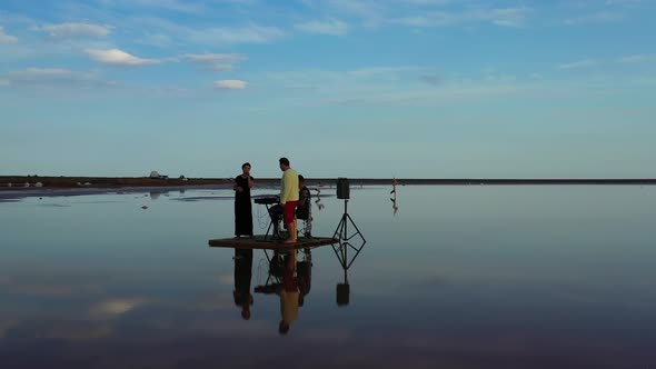 Drone View on a Band Performing on a Small Raft in the Sea, Playing Music,  alt