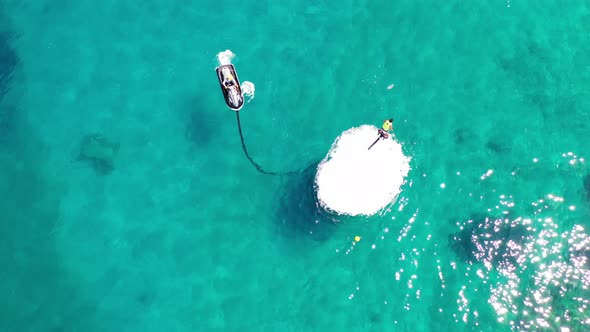 Aerial View of a Person Flyboarding in the Sea. Elounda, Crete, Greece