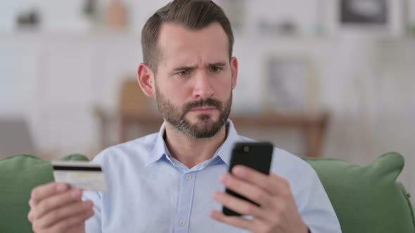 Man Reacting To Online Shopping Problem on Smartphone alt