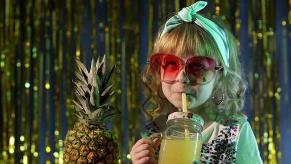Trendy Stylish Child Kid with Pineapple Fruit Drinking Juice in Futuristic Club with Neon Light alt