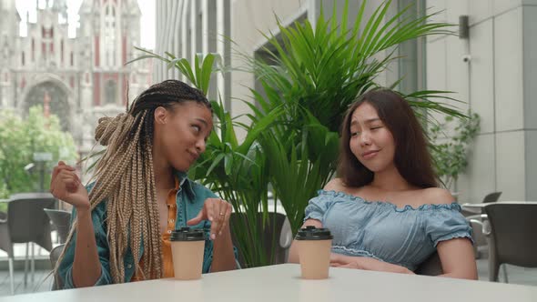 Mixed Race Woman Showing Asian Female a Ring of Getting Marriage alt