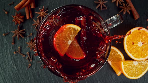 Super Slow Motion Shot of Orange Slice Falling and Splashing Into Mulled Wine at 1000 Fps. alt