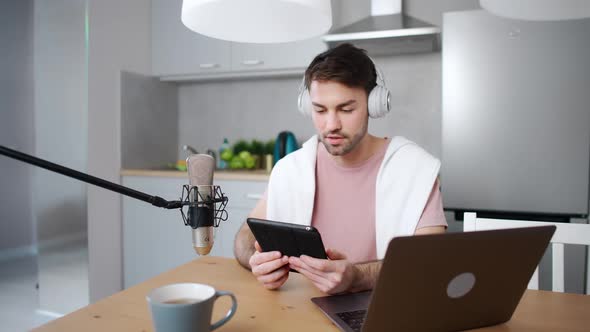 Young Man Streamer Makes a Live Podcast for Social Networks Remotely Working While Sitting in the alt