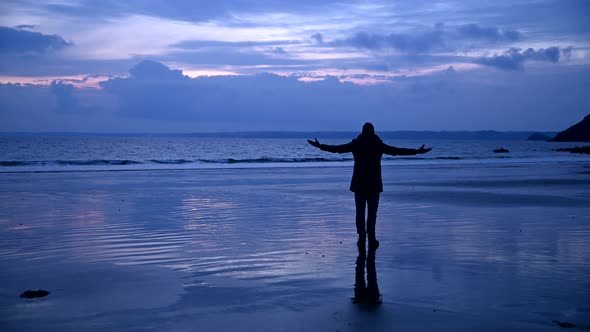 Carefree man enjoying empty beach alt