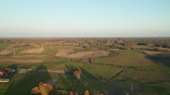 AERIAL: Nature Landscape with Green Plains and Forest with Sky in Background