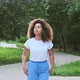 Relaxed Mixed Race Curly Young Modern Female Walking at Summer Forest Park Spending Time Outdoor - VideoHive Item for Sale