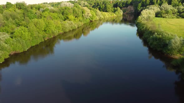 Drone Flight Over Water and Trees From a Height alt