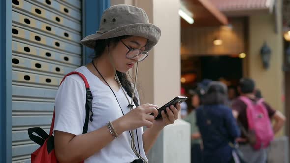 Young Asian woman hand using smartphone at the market.