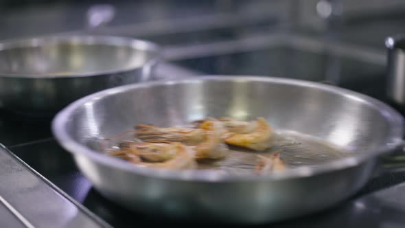 High Angle View Cooking Pan with Shrimps Frying Inside Shaking in Slow Motion alt