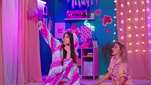 Brunette Lady in a Unicorn Pajama and Her Blonde