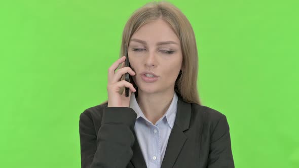 Ambitious Businesswoman Talking on Smartphone Against Chroma Key alt