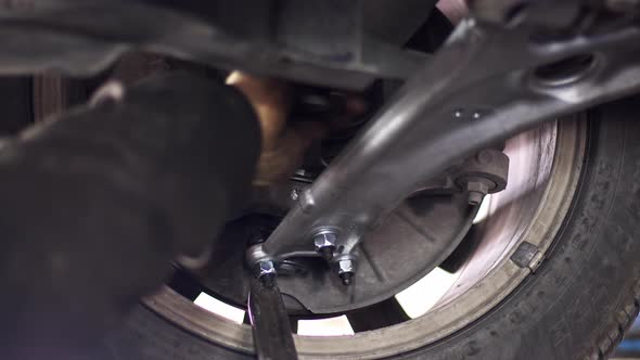 Changing The Car Undercarriage Suspension Arm In The Repair Shop alt