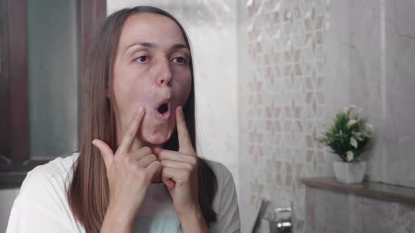 Young Woman is Doing Facial Gymnastics Against Wrinkles