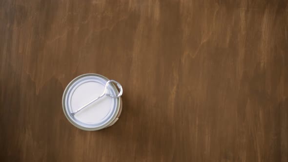 Paint in metal paint can and painters tools on a wood board alt