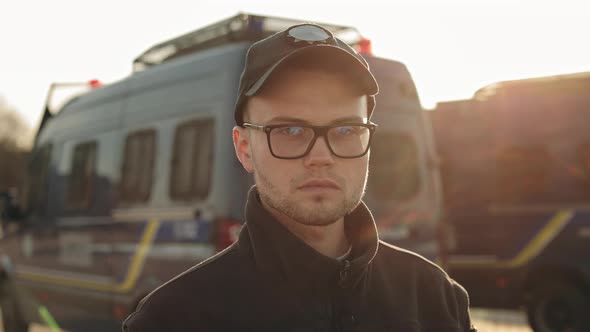 A Man in a Police Uniform is Turning His Head and Looking Seriously at the Camera alt