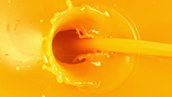 Super Slow Motion Shot of Pouring Fresh Orange Juice at 1000Fps. alt