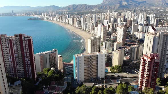 Aerial footage of the Playa Levante beach, hotels, buildings and restaurants
